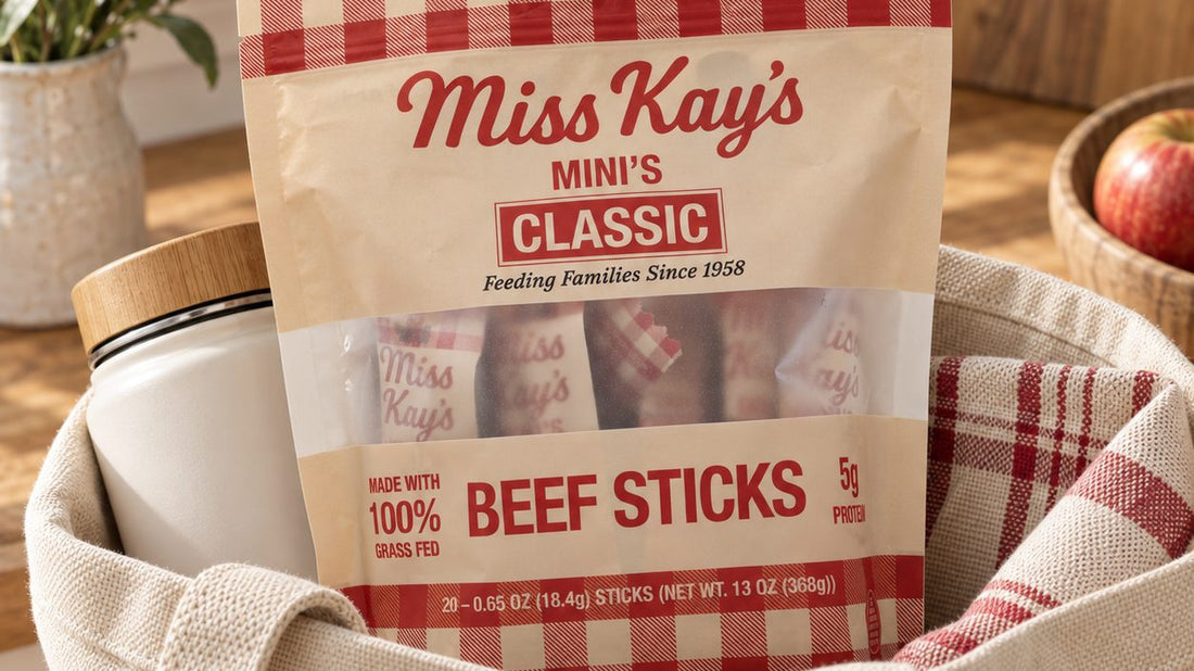 A bag of Miss Kay's Mini's beef sticks packed in a canvas tote bag next to a water bottle