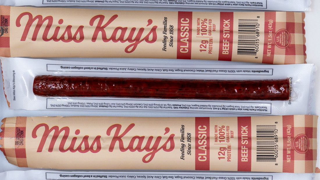 Miss Kay's Classic beef sticks in a row, front labels alternating with clear backs that show the stick inside