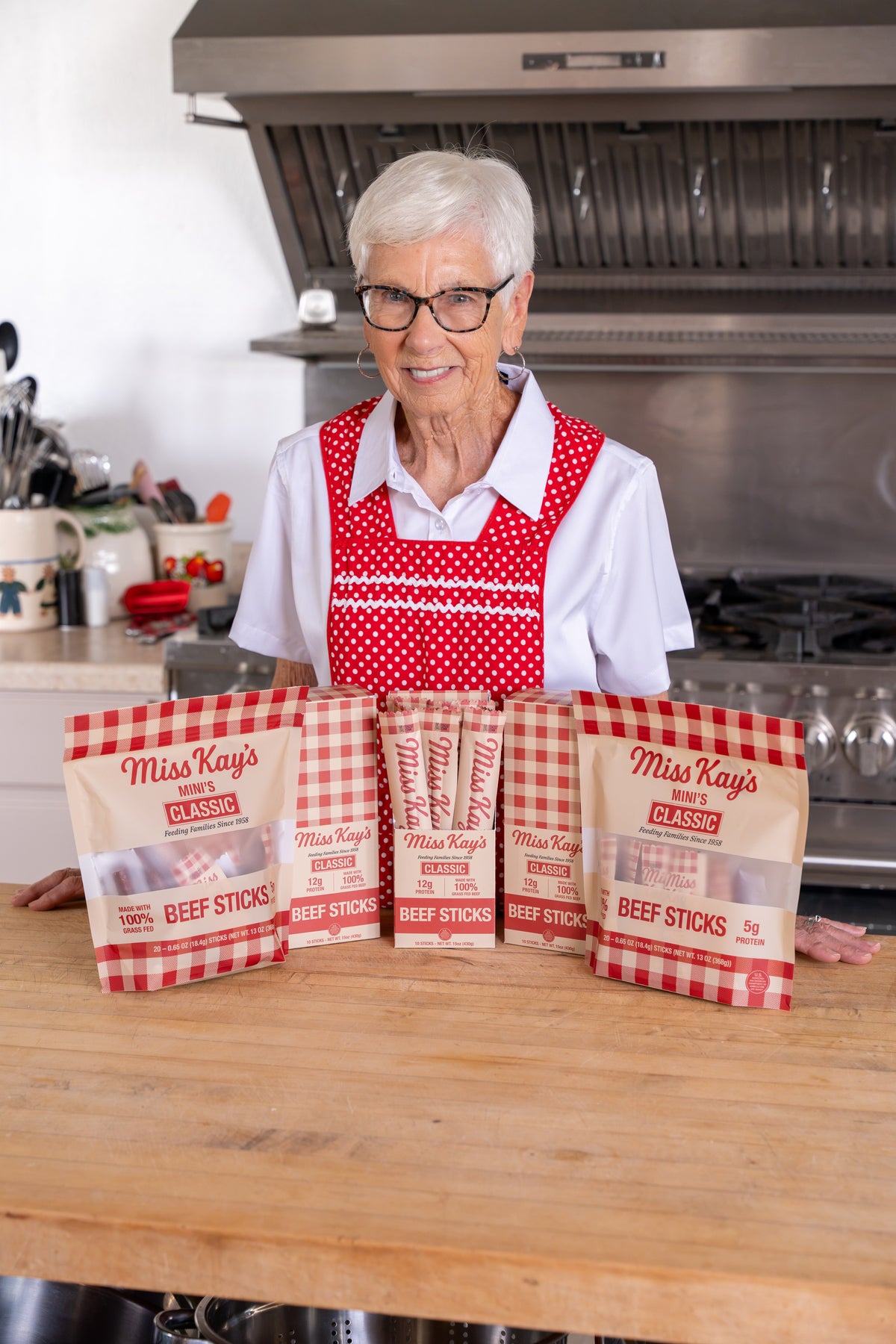 Miss Kay seasoning a batch of grass-fed beef sticks in her kitchen